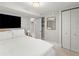 Bedroom with a large bed, TV, closet, mirror, and neutral decor, creating a comfortable and functional space at 4250 Wyandot St, Denver, CO 80211