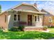 Charming single-story home featuring a cozy front porch with a swing and well-maintained landscaping at 4250 Wyandot St, Denver, CO 80211