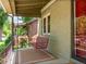 Inviting front porch with a classic wooden swing, offering a relaxing spot to enjoy the neighborhood views at 4250 Wyandot St, Denver, CO 80211