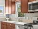Bright and modern kitchen with updated appliances, quartz counters, and stainless steel fixtures at 4250 Wyandot St, Denver, CO 80211