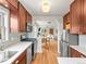 Modern kitchen open to the living room, featuring stainless steel appliances and updated cabinets at 4250 Wyandot St, Denver, CO 80211