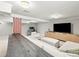 Cozy living room with a large TV, brick column, and white, comfortable sectional sofa, creating a relaxing atmosphere at 4250 Wyandot St, Denver, CO 80211
