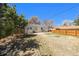 Lush backyard featuring a well-kept lawn, wooden fence, and detached garage at 3492 S Elm St, Denver, CO 80222