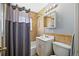 Tiled bathroom featuring a shower-tub combo, vanity with mirror, and toilet at 3492 S Elm St, Denver, CO 80222