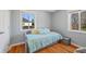 Cozy bedroom featuring hardwood floors, a comfortable daybed, and natural lighting at 3492 S Elm St, Denver, CO 80222