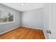 Simple bedroom featuring hardwood floors and a window with natural light at 3492 S Elm St, Denver, CO 80222