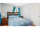 Comfortable bedroom featuring hardwood floors, a cozy bed, and natural lighting at 3492 S Elm St, Denver, CO 80222