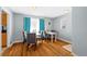 Cozy dining room featuring hardwood floors, a modern table, and bright, natural lighting at 3492 S Elm St, Denver, CO 80222