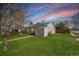 Charming single-story home with a well-manicured front lawn, sidewalk and landscaping at 3492 S Elm St, Denver, CO 80222