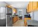 Functional kitchen featuring stainless steel appliances and ample cabinet space overlooking the dining area at 3492 S Elm St, Denver, CO 80222