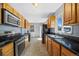 Well-equipped kitchen with stainless steel appliances, tile floors, and ample cabinet space at 3492 S Elm St, Denver, CO 80222