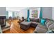 Bright living room with hardwood floors, large sectional sofa, and ample natural light at 3492 S Elm St, Denver, CO 80222