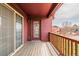 Cozy covered balcony with wooden floors and matching railing, perfect for outdoor relaxation and enjoying the neighborhood view at 2552 W 82Nd Ln # C, Westminster, CO 80031