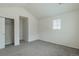 This bedroom features neutral walls, gray carpet, and a closet for ample storage at 2552 W 82Nd Ln # C, Westminster, CO 80031