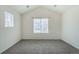 Bright bedroom featuring vaulted ceilings, large windows, and neutral carpet at 2552 W 82Nd Ln # C, Westminster, CO 80031