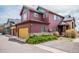 Two-story home with a two car garage, stone accents, and colorful facade at 2552 W 82Nd Ln # C, Westminster, CO 80031