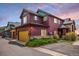 Eye-catching exterior showcases colorful siding, stone accents, lush landscaping, and a convenient two-car garage at 2552 W 82Nd Ln # C, Westminster, CO 80031