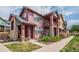 Two-story home featuring a porch with stone columns and green lawn at 2552 W 82Nd Ln # C, Westminster, CO 80031