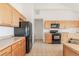 Bright kitchen features wood cabinets, black appliances, and tiled floors at 2552 W 82Nd Ln # C, Westminster, CO 80031