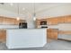 Bright open kitchen featuring breakfast bar, black appliances, and light wood cabinets at 2552 W 82Nd Ln # C, Westminster, CO 80031