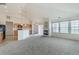 An open living room features a fireplace, large windows and flows into the kitchen area at 2552 W 82Nd Ln # C, Westminster, CO 80031