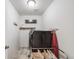 Efficient laundry room equipped with modern washer and dryer units and functional shelving at 1121 Acadia Cir, Erie, CO 80516