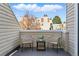 Cozy balcony featuring two chairs, a small table, and a view of the neighborhood at 2658 S Xanadu Way # B, Aurora, CO 80014