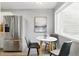 Cozy breakfast nook with stainless steel fridge, modern art, and natural light from the window at 2658 S Xanadu Way # B, Aurora, CO 80014