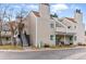 Exterior view of a multi-story condo building with tidy landscaping, stairs leading to second-floor units, and ample parking at 2658 S Xanadu Way # B, Aurora, CO 80014