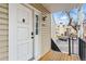 Exterior view of a front door with a digital lock and a view of a parking area and neighborhood in the distance at 2658 S Xanadu Way # B, Aurora, CO 80014