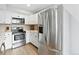 Spacious kitchen features stainless steel appliances, white cabinets, and ample countertop space at 2658 S Xanadu Way # B, Aurora, CO 80014