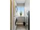 Efficient laundry area with a stacked washer/dryer, storage, and a bright window at 2658 S Xanadu Way # B, Aurora, CO 80014