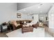 Spacious living area with a comfortable leather sofa, a stylish ottoman, and minimalist decor in a light-filled setting at 2658 S Xanadu Way # B, Aurora, CO 80014