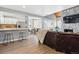 Open concept living area with sleek countertops, stainless steel appliances, and access to a charming outdoor balcony at 2658 S Xanadu Way # B, Aurora, CO 80014