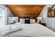 Bedroom boasts a unique wood ceiling and comfortable bed with stylish decor at 2658 S Xanadu Way # B, Aurora, CO 80014