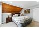 Comfortable bedroom features a wood ceiling, stylish decor, and cozy lighting at 2658 S Xanadu Way # B, Aurora, CO 80014