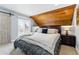 Bedroom features a wood ceiling, sliding barn door to a balcony, and comfortable furnishings at 2658 S Xanadu Way # B, Aurora, CO 80014