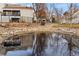 Scenic view of the community pond with rock landscaping and serene water reflections at 2658 S Xanadu Way # B, Aurora, CO 80014