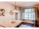 Bright dining area with wood floors, modern lighting, and a bench seating at 535 Lost Valley Pt, Castle Rock, CO 80108