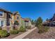 View of the side of the houses along a walking path with manicured shrubs and a retaining wall at 535 Lost Valley Pt, Castle Rock, CO 80108