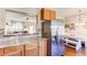 Open-concept kitchen with stainless steel refrigerator and view of dining area at 535 Lost Valley Pt, Castle Rock, CO 80108