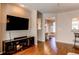 Comfortable living room with wood floors, a large TV, and an open floor plan at 535 Lost Valley Pt, Castle Rock, CO 80108