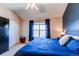 The main bedroom features a vaulted ceiling, dark curtains, and a blue comforter at 535 Lost Valley Pt, Castle Rock, CO 80108