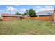 Large backyard with a full fence and a mix of green and sparse grass at 544 S 3Rd Ave, Brighton, CO 80601
