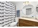 Bathroom with a vanity, toilet, and a shower with a unique patterned curtain at 544 S 3Rd Ave, Brighton, CO 80601