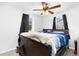 Comfortable bedroom featuring a bed with a blue comforter, ceiling fan and natural light at 544 S 3Rd Ave, Brighton, CO 80601