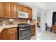 Kitchen featuring classic wood cabinetry, a modern stainless steel oven, and neutral countertops at 544 S 3Rd Ave, Brighton, CO 80601