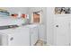 Functional laundry room with washer, dryer, storage shelves, and a window at 544 S 3Rd Ave, Brighton, CO 80601