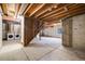 Unfinished basement with exposed wood ceiling, concrete floors and visible laundry machines at 717 Walden Ct, Highlands Ranch, CO 80126