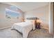 Bright bedroom with a large window, a bed with white bedding, and two bedside tables at 717 Walden Ct, Highlands Ranch, CO 80126